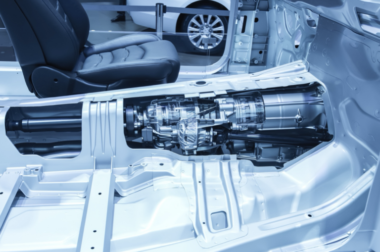 Car chassis cutaway view showing the transmission and drivetrain system.